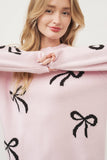 Pink sweater with black bows