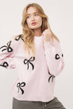 Pink sweater with black bows