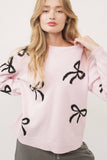 Pink sweater with black bows