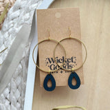 Earrings: large gold hoop with black teardrop