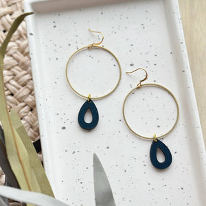 Earrings: large gold hoop with black teardrop