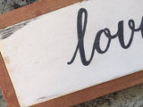 love never fails wood sign